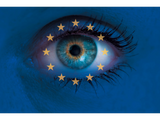 Discover Eye looks through Europe flag background concept
