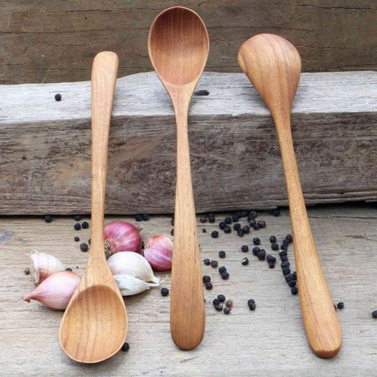 Wooden spoon handmade from solid teak wood with long bended handle