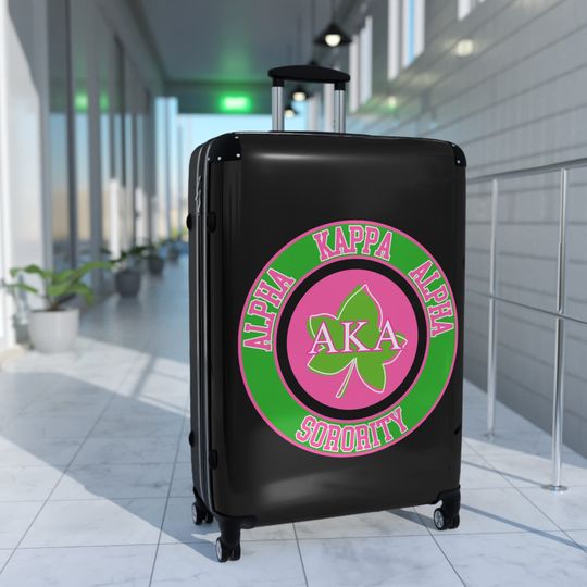 Cute Alpha Kappa Sorority Suitcase - AKA Pink and Green Traveling Soror Luggage with Greek Letters and Round Design.