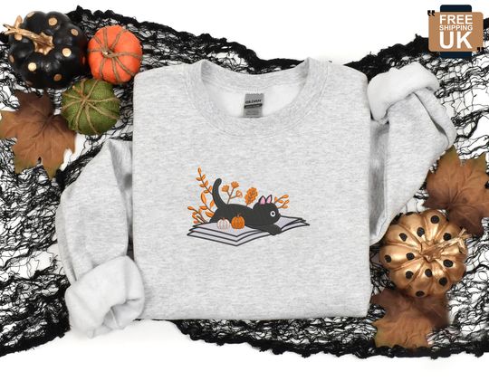 Discover Embroidered Halloween Cat Sweater, Vintage Black Cat Lying on Book Sweatshirt