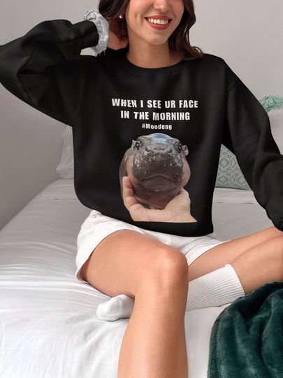 Discover The baby pygmy hippo Moo Deng ,Unisex Heavy Blend Crewneck Sweatshirt