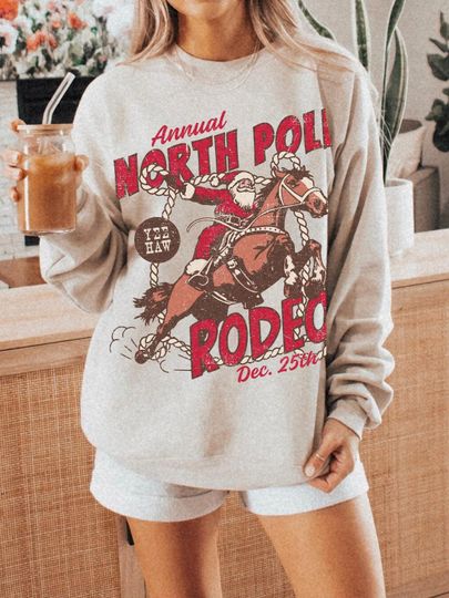 Discover North Pole Rodeo Sweatshirt UNISEX Cowboy Santa Crewneck Country Christmas Shirt Western Santa Claus PJ Groovy Festive Vintage Santa Rodeo