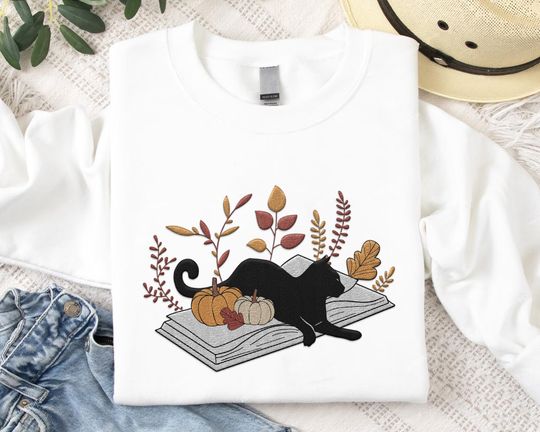 Embroidered Cute Black Cat Lying On Book With Floral Pumpkin Sweatshirt, Embroidery Autumn Vibes Cat Sweater, Halloween Gift For Book Lover