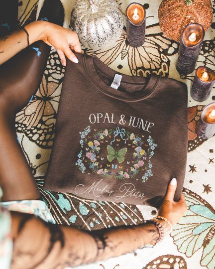 Dark Chocolate Sweatshirt Mockup: Colorful Photo of Model Folding Dark Chocolate Gildan 18000 Crewneck, Cozy Lifestyle Mockup for Halloween