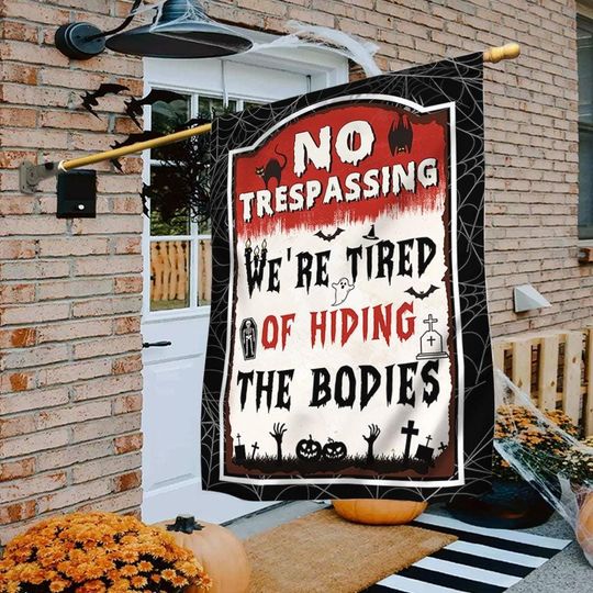 Discover Funny Halloween Garden Flag: "We're Tired of Hiding the Bodies"