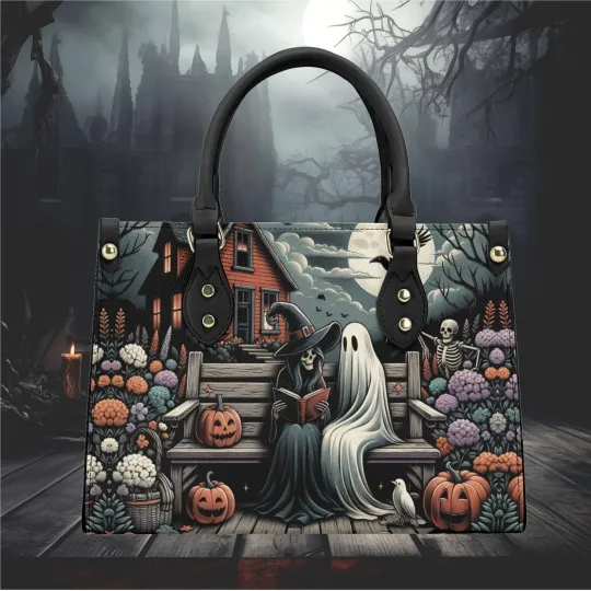Discover Leather Handbag With Handle Halloween witch and a ghost reading a book design
