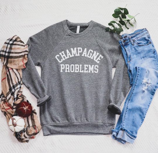 Discover Champagne Problems Bella Canvas Sweatshirt | Unisex Fleece Raglan | Cozy Casual Wear | Ideal Gift for Wine Lovers | New Year's Eve
