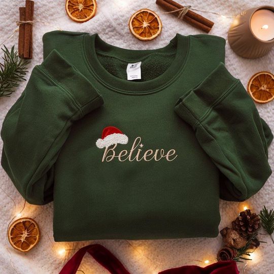 Discover EMBROIDERED Believe Christmas Sweatshirt, Santa Hat Crewneck, Minimal Holiday Sweater, Cozy Xmas Shirt, Christmas Family Shirts, Merry Xmas