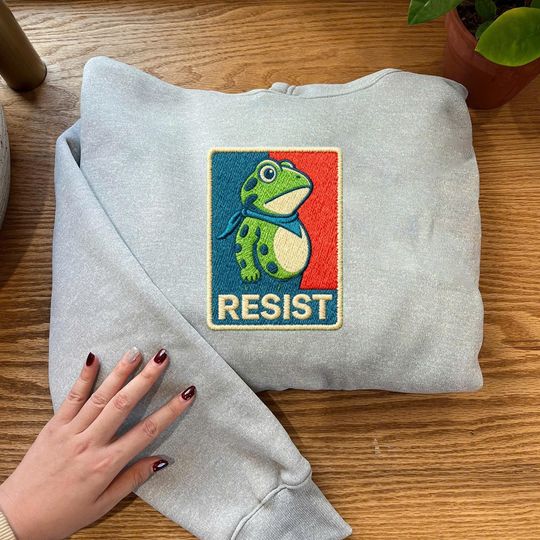 Discover Embroidered Frog Resist Sweatshirt, Anti-ICE Protest Embroidery Hoodie, Portland Frog Embroidered Shirt, Protest Symbol Of Resistance Shirt