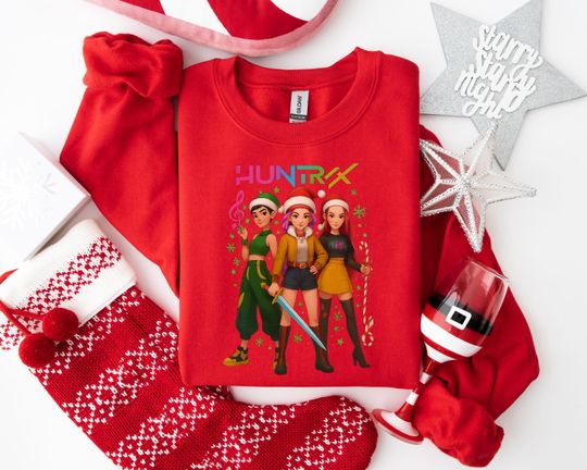 Discover HUNTRX Holiday Adventure Sweatshirt, Empowering Christmas Apparel with Santa Hat Characters, Festive Cartoon Graphic for Young Fans