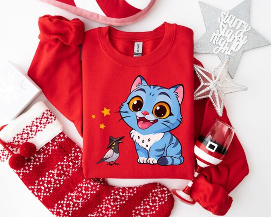 Discover Whimsical Blue Cat Sweatshirt, Playful Cartoon Animal Hoodie, Magic Bird with Witch Hat Graphic for Fantasy Lovers