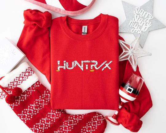 Discover HUNTRX Christmas Sweatshirt, Festive Snow and Bells Holiday Design, Funny Xmas Party Hoodie for Brand Fans, Playful Winter Apparel