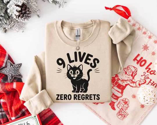 Discover Cozy Cat Sweatshirt - Unisex Cotton Hoodie Gift - '9 Lives Zero Regrets' Black Cat Graphic Pullover - t-shirt | tee Perfect Gift for Any Occ