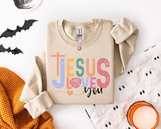 Discover Feel the Love with Our 'Jesus Loves You' Sweatshirt - Perfect for Faithful Hearts in Soft Pastel Colors and Vintage Style