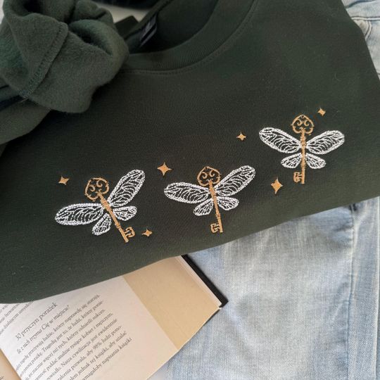 Discover Embroidered The Winged Keys, Flying Key, Wizard Wand Shop Embroidered Sweatshirt, Wizard Book Shop, Gift For Book Nerd, Bookish Pullover
