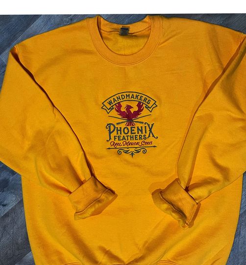 Discover Embroidered Phoenix Wandmaker Sweatshirt: Wizard World Gift