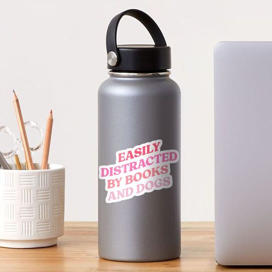 Discover Easily distracted by books and dogs Sticker