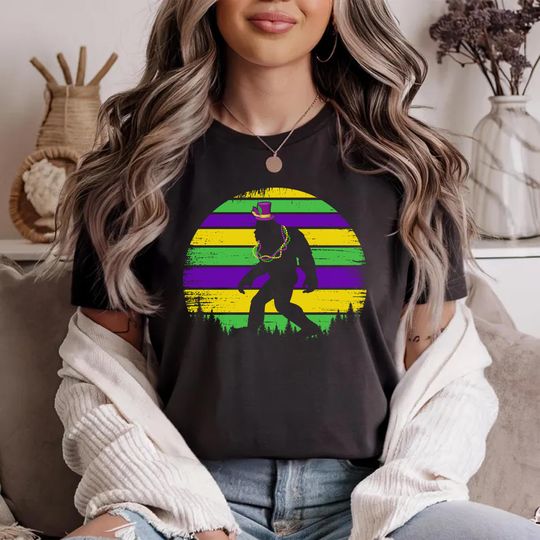 Discover Mardi Gras Bigfoot T-Shirt, Sasquatch Carnival Tee, Fat Tuesday Retro Sun Top, Purple Green Gold Beads Shirt