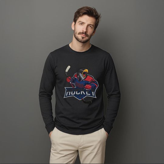 Unisex Long Sleeve Tee featuring a fierce bald eagle mascot in a USA Hockey jersey, perfect for patriotic fans and Team USA supporters.