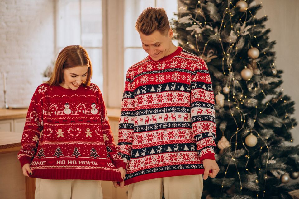 couple wearing on National Ugly Christmas Sweater Day