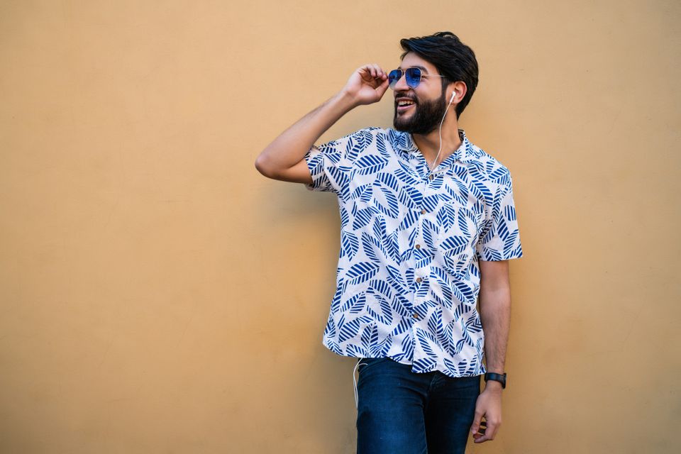 man wearing a Hawaiian shirt and jeans