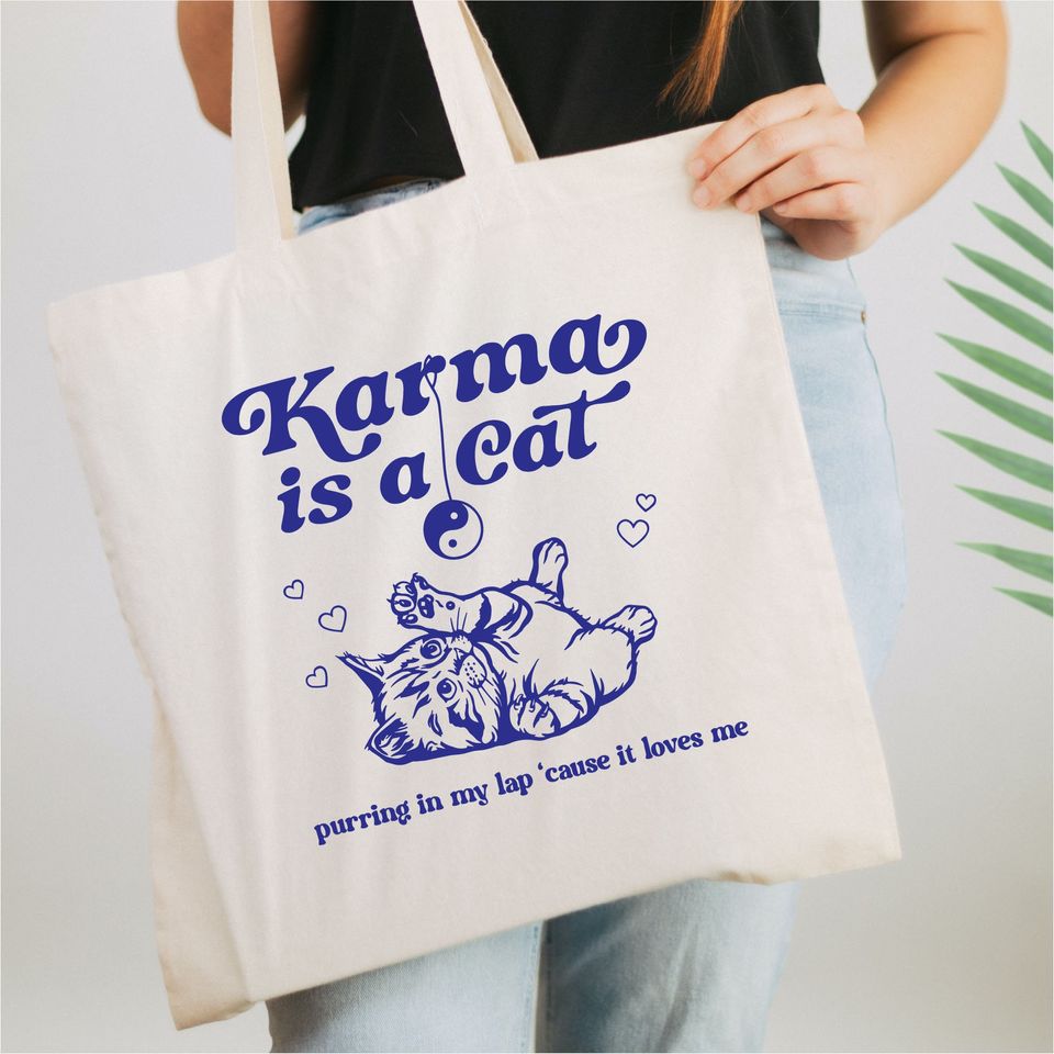 Karma is a cat purring in my lap tote bag